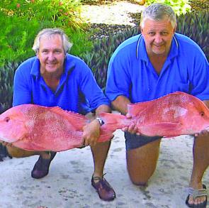 Pat and Chris show off two red emperors caught at Wilson Island.